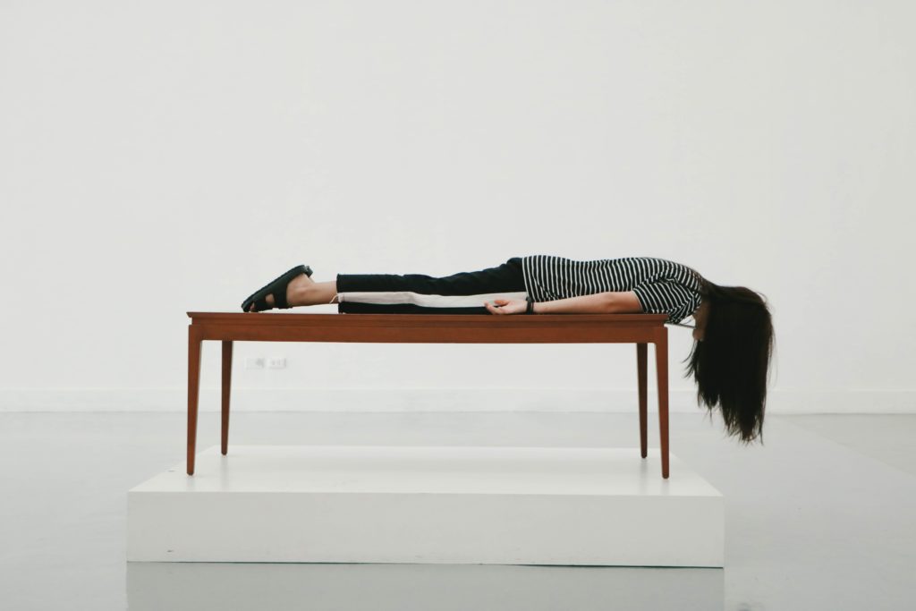 woman laying face down on table